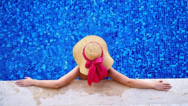 Woman relaxing in a swimming pool of a hotel