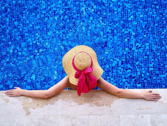 Woman relaxing in a swimming pool of a hotel