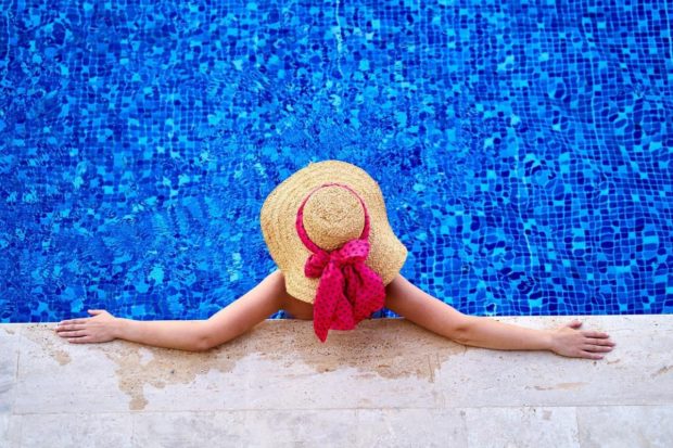 Woman relaxing in a swimming pool of a hotel