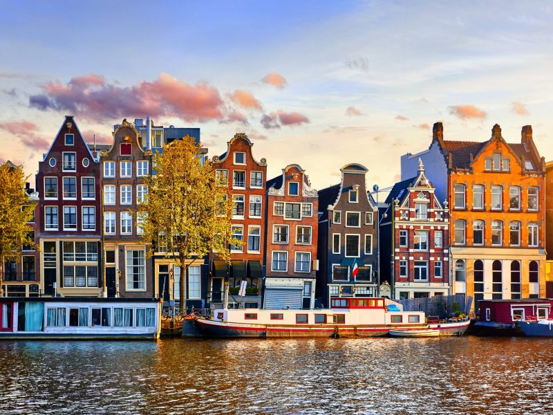 Amsterdam Netherlands dancing houses over river Amstel landmark in old european city spring landscape.