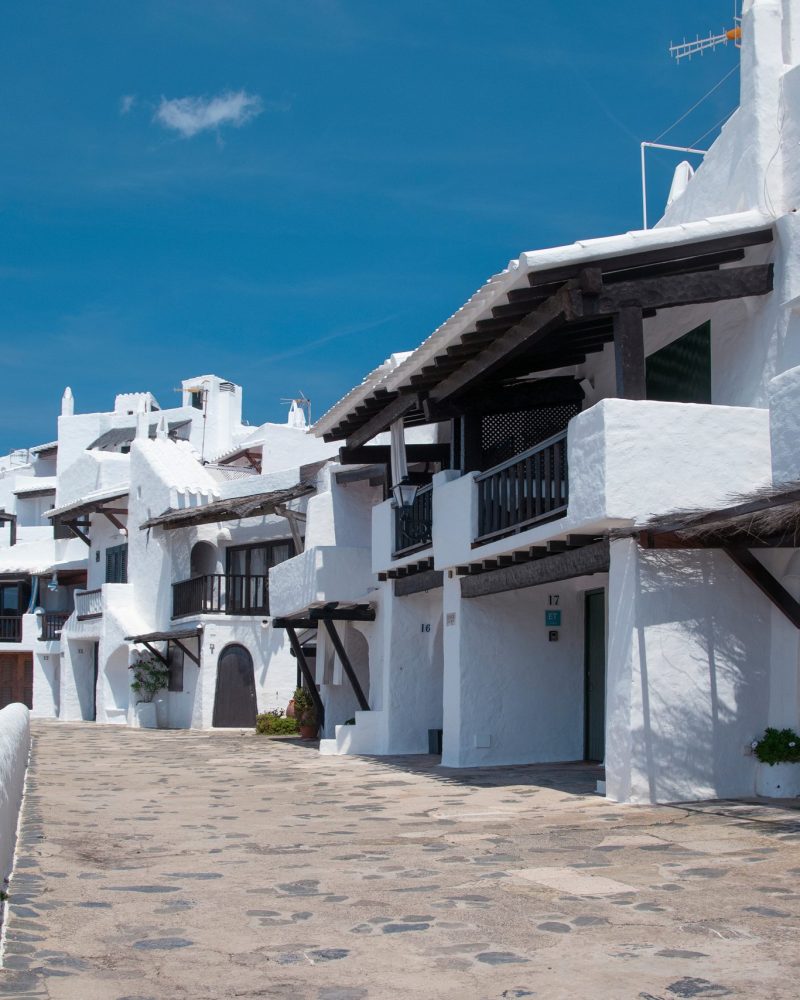 Streets and white walls of touristic fishing village of Binibeca Vell in Menorca, Spain.